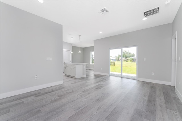 unfurnished living room with light wood-type flooring