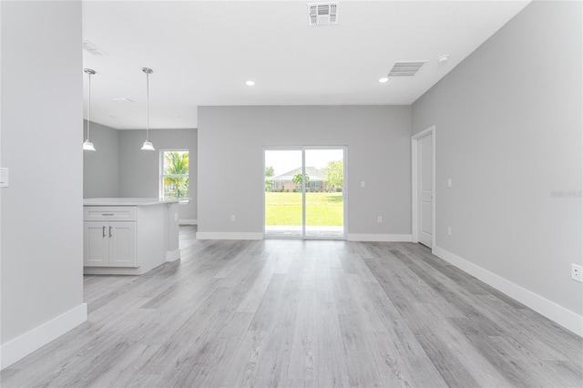 unfurnished living room with light hardwood / wood-style floors