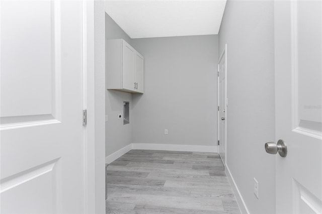 laundry area with light hardwood / wood-style flooring, cabinets, and hookup for an electric dryer