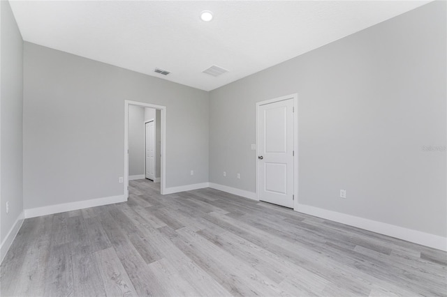 spare room with light wood-type flooring