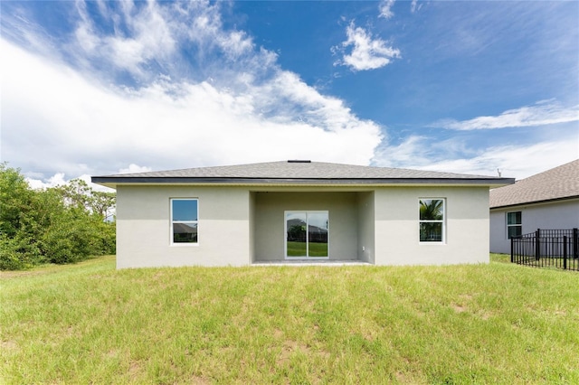 rear view of house with a lawn