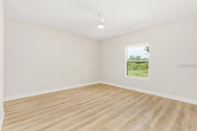 empty room featuring light wood-type flooring and ceiling fan