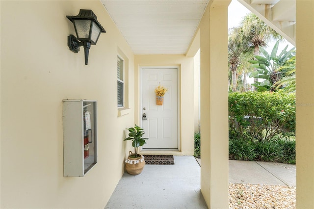 entrance to property featuring stucco siding