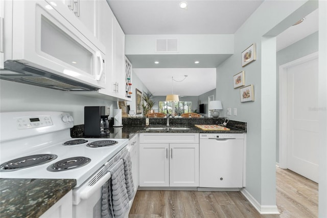 kitchen with visible vents, light wood-style flooring, white cabinets, white appliances, and a sink