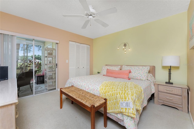 carpeted bedroom featuring access to outside, a ceiling fan, and a textured ceiling