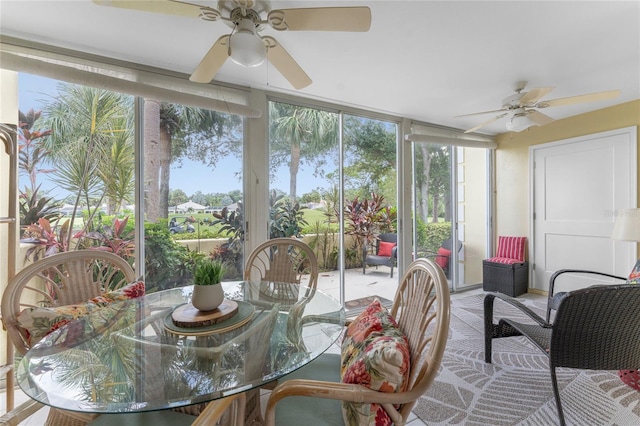 sunroom / solarium featuring ceiling fan