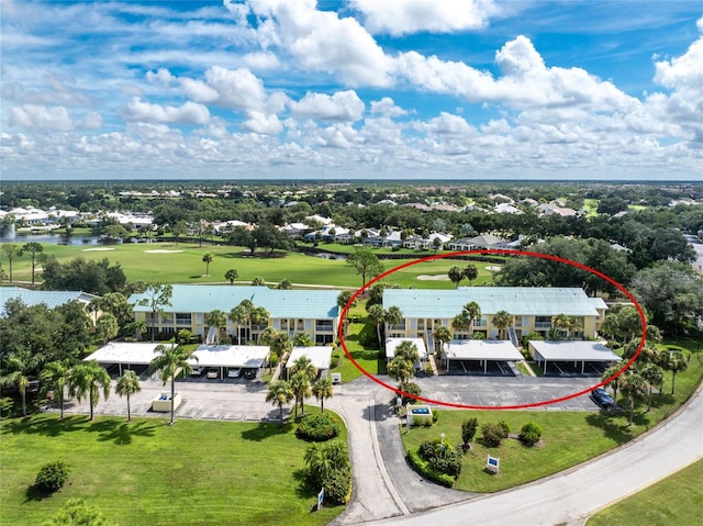 drone / aerial view featuring view of golf course and a water view