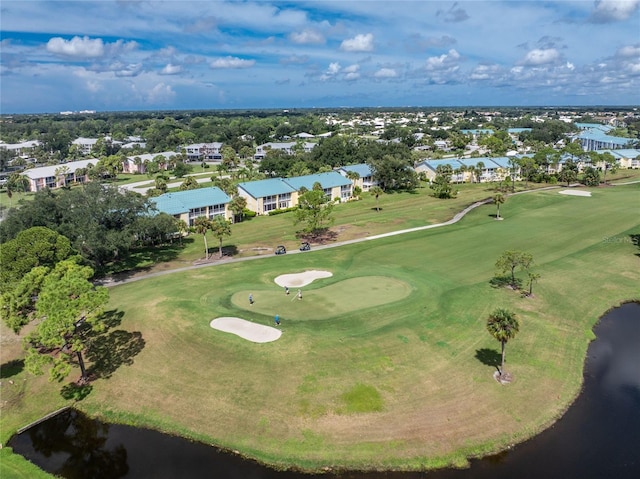 drone / aerial view with view of golf course, a water view, and a residential view