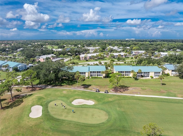 drone / aerial view featuring view of golf course and a residential view