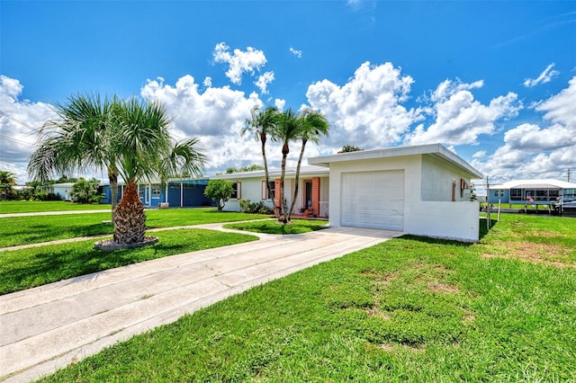 single story home with a garage and a front lawn