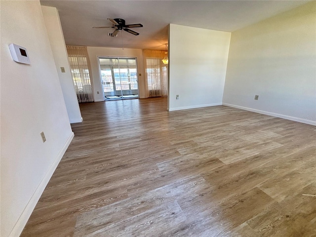 unfurnished living room featuring wood-type flooring and ceiling fan