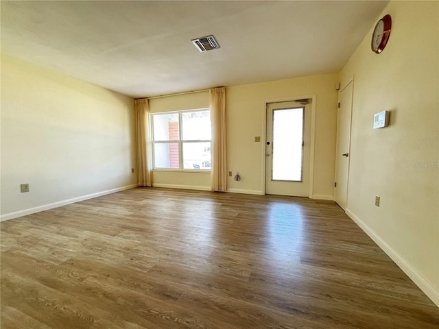 unfurnished room with hardwood / wood-style flooring