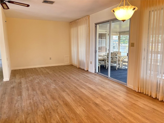 empty room with hardwood / wood-style floors and ceiling fan