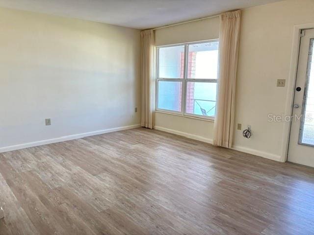 spare room with wood-type flooring