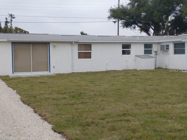 rear view of property featuring a yard