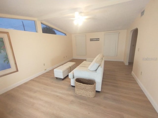 living area featuring light wood-type flooring and lofted ceiling