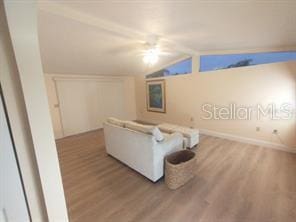 living room with vaulted ceiling and hardwood / wood-style floors