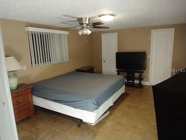 tiled bedroom with ceiling fan