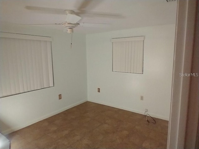 spare room featuring ceiling fan and tile patterned flooring