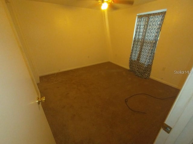 empty room with ceiling fan and carpet floors