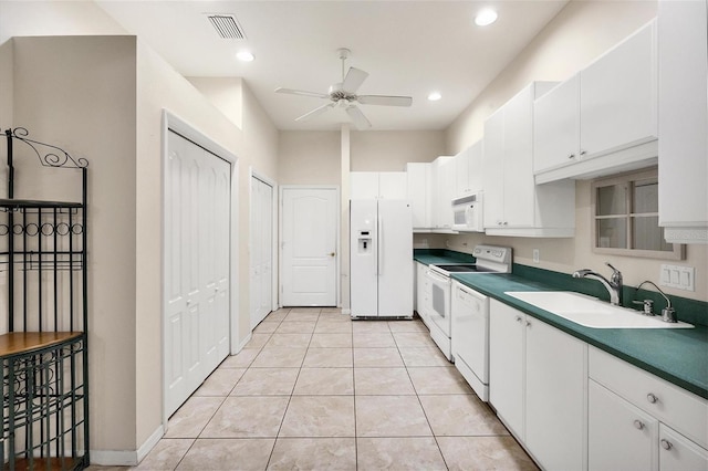 kitchen featuring ceiling fan, white cabinets, light tile patterned floors, sink, and white appliances