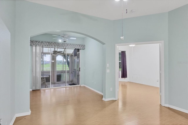 unfurnished room with ceiling fan and wood-type flooring