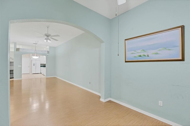 tiled empty room with ceiling fan