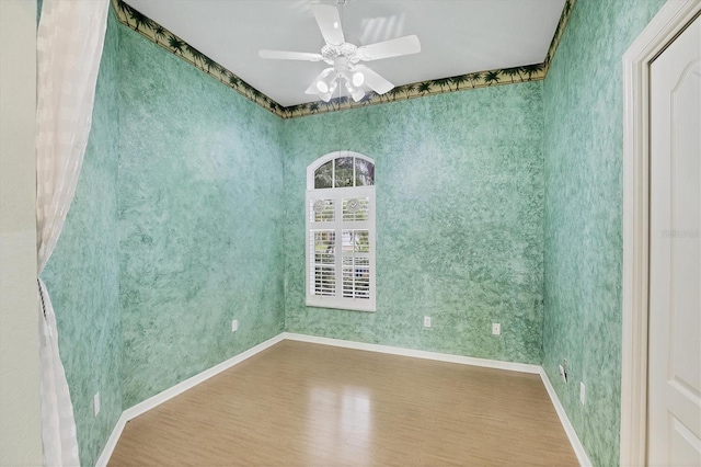 spare room featuring ceiling fan and hardwood / wood-style flooring