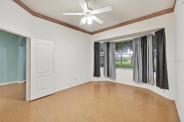 unfurnished room with ceiling fan, light hardwood / wood-style floors, and crown molding