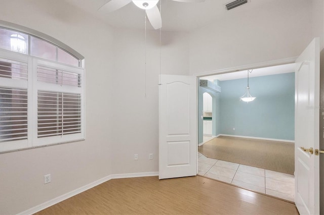 spare room featuring hardwood / wood-style flooring and ceiling fan