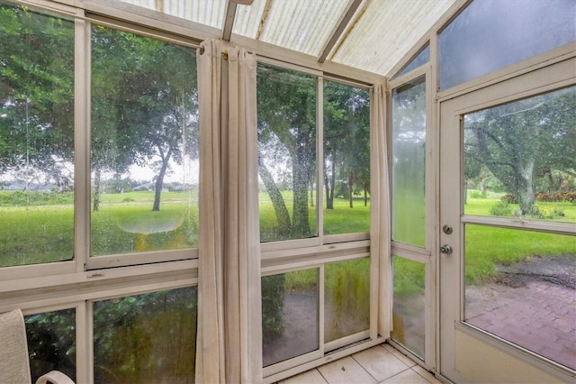 unfurnished sunroom featuring lofted ceiling