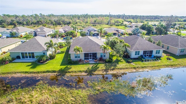 drone / aerial view with a water view and a residential view