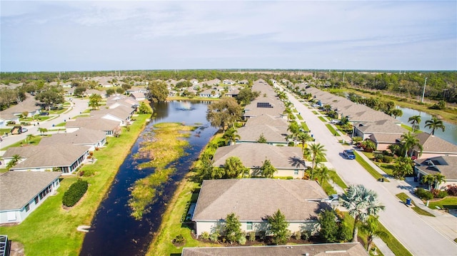 drone / aerial view featuring a residential view and a water view