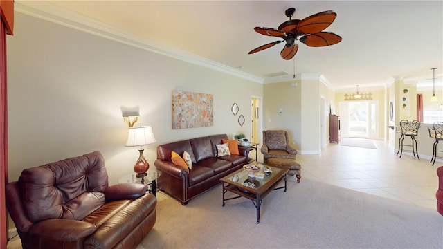 living area featuring light colored carpet, ornamental molding, light tile patterned flooring, baseboards, and ceiling fan with notable chandelier