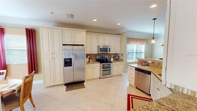 kitchen with light tile patterned floors, visible vents, appliances with stainless steel finishes, crown molding, and backsplash