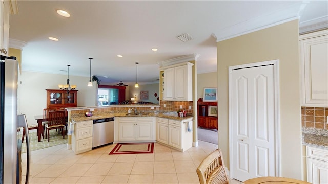 kitchen with visible vents, appliances with stainless steel finishes, a peninsula, crown molding, and pendant lighting