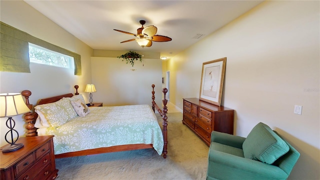 bedroom with a ceiling fan, light colored carpet, and visible vents