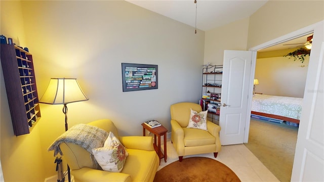 living area with lofted ceiling, carpet, and a ceiling fan