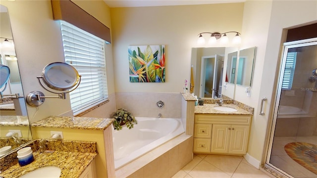 bathroom with a shower stall, a sink, a garden tub, and tile patterned floors