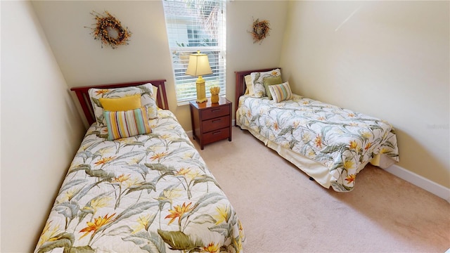 carpeted bedroom featuring baseboards