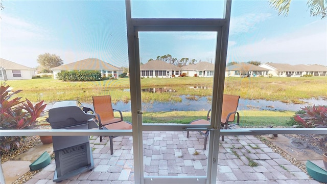 doorway to outside featuring a water view and a residential view