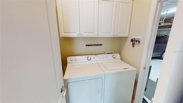 laundry room with washer and clothes dryer and cabinet space