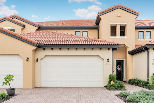 mediterranean / spanish-style home with a garage