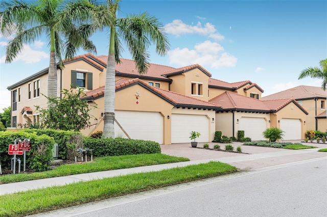 mediterranean / spanish home featuring a garage