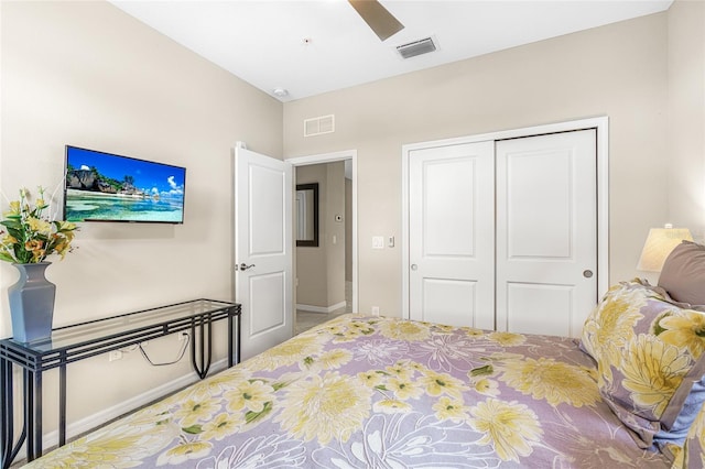 carpeted bedroom with ceiling fan and a closet