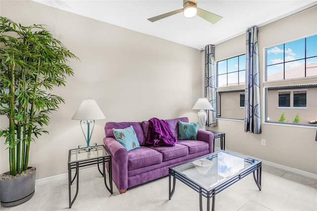 living room featuring ceiling fan and tile patterned flooring