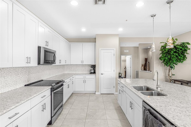 kitchen featuring stainless steel appliances, decorative backsplash, white cabinetry, sink, and light tile patterned floors