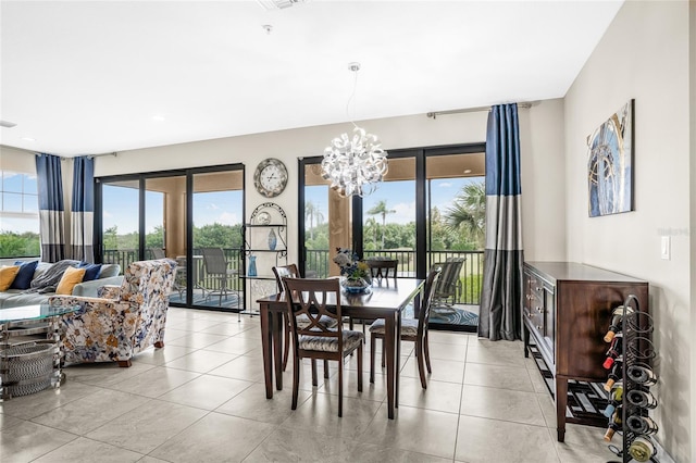 tiled dining space featuring french doors and a chandelier