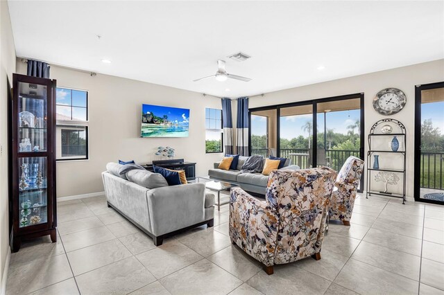 tiled living room featuring ceiling fan and a wealth of natural light