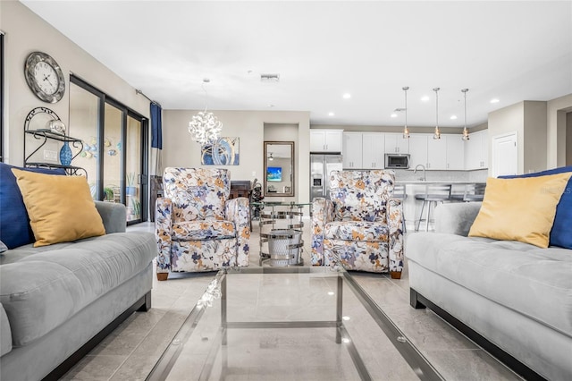 tiled living room featuring a notable chandelier